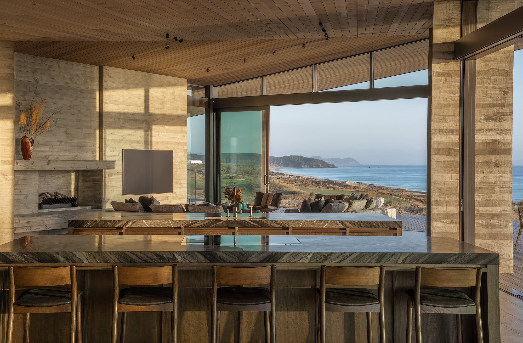 Kitchen with stone island and coastal view