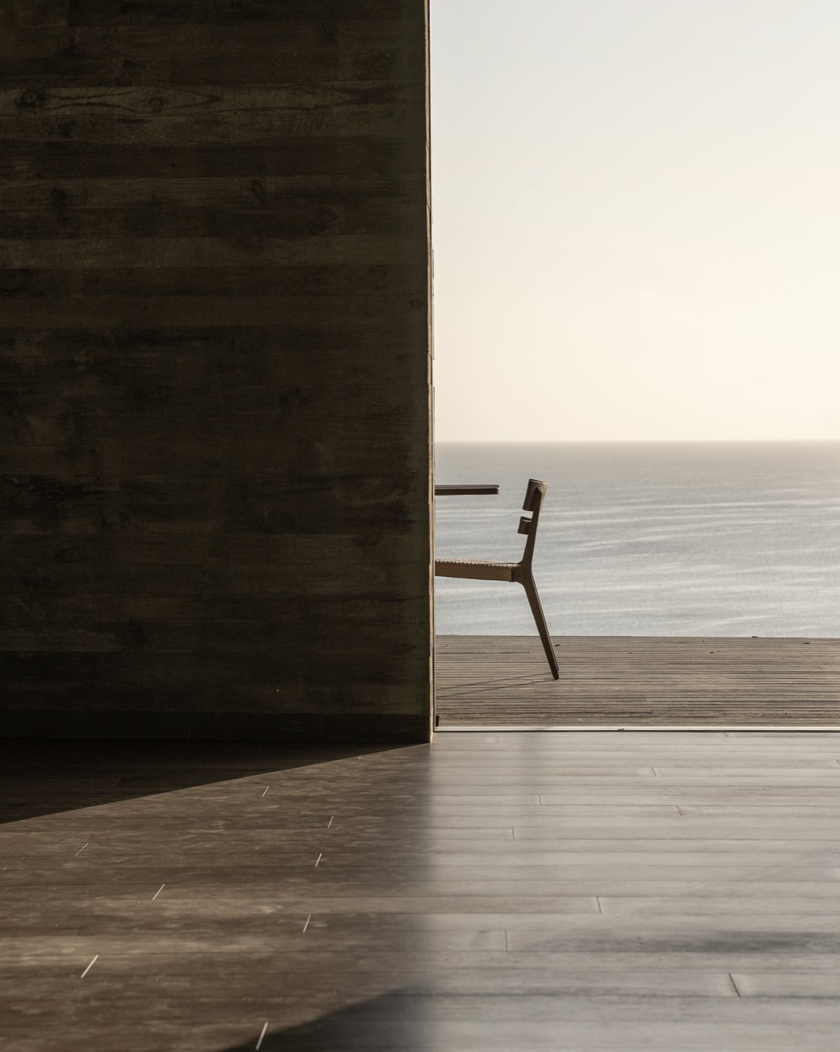 Board-formed concrete and a chair by the ocean
